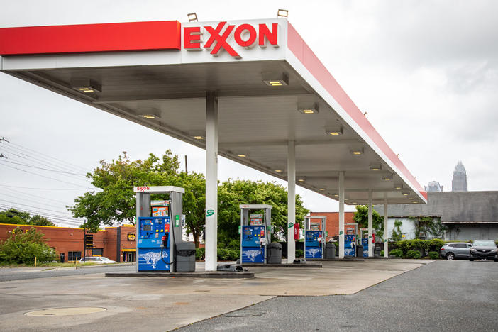 Pictured are pumps at an Exxon gas station in Charlotte, N.C. A tiny fund got two board members elected to the oil giant's board, delivering a historic defeat to ExxonMobil.