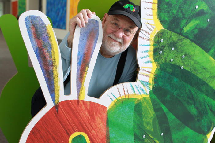 Eric Carle with a cutout of his famously hungry caterpillar at the Eric Carle Museum of Picture Book Art in Amherst, Mass.