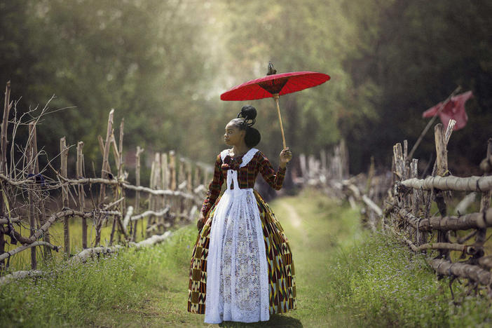 In<em> Voyages of an African Victorian, </em>a woman wears a Victorian-style dress made of African fabrics.