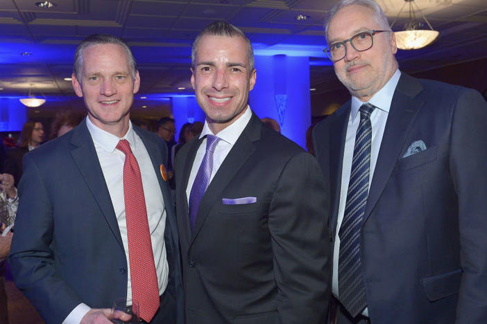 A Martinez (center) has been named a new co-host for NPR's <em>Morning Edition</em>. He is shown with Southern California Public Radio CEO Herb Scannell (right) at a fundraising gala for KPCC in March 2019.