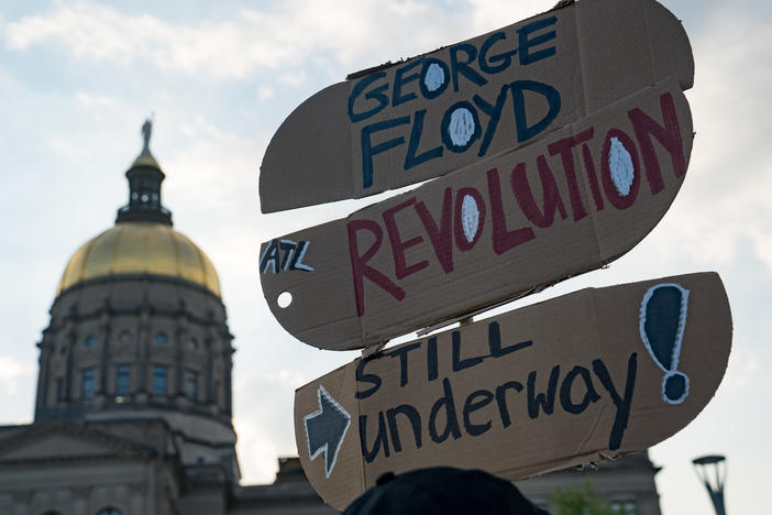 People gather to memorialize the life of George Floyd on the first anniversary of his death on Tuesday in Atlanta. America's corporations pledged to boost diversity soon after his death last year, but progress can be slow.