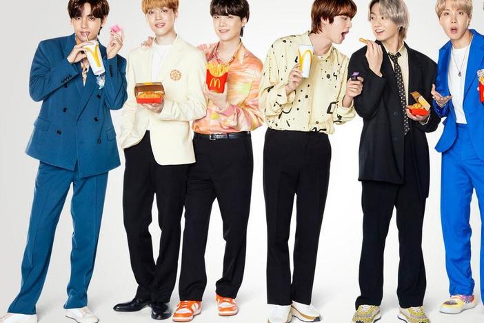 K-Pop group BTS poses with their McDonald's meal.
