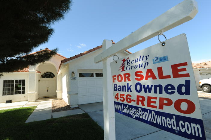 A house under foreclosure in Las Vegas displays a sign on Oct. 15, 2010, saying that it's now bank-owned. Sen. Sherrod Brown has vowed increased scrutiny of Wall Street banks, in part after a surge in foreclosures in his hometown in Ohio over a decade ago.