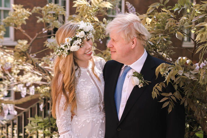 Prime Minister Boris Johnson poses with his wife Carrie Symonds in the garden of 10 Downing Street following their wedding at Westminster Cathedral on Saturday in London.