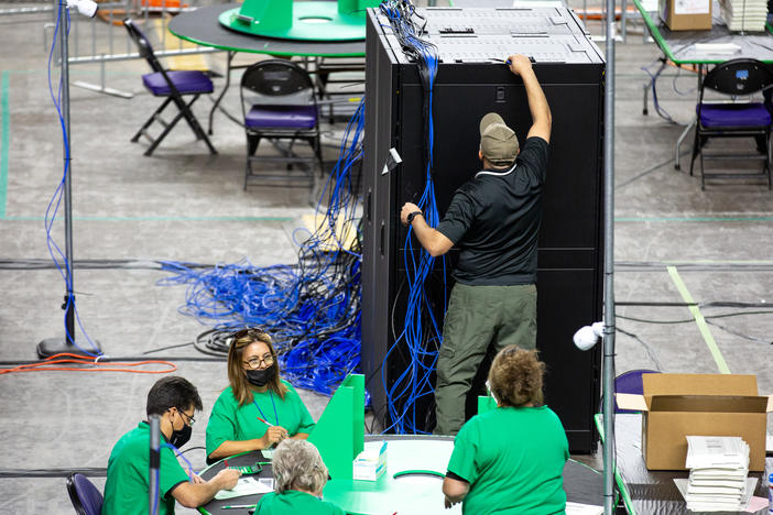 Contractors working for Cyber Ninjas, the company hired by the Republican-led Arizona state Senate, examine and recount ballots from the 2020 general election on May 3.