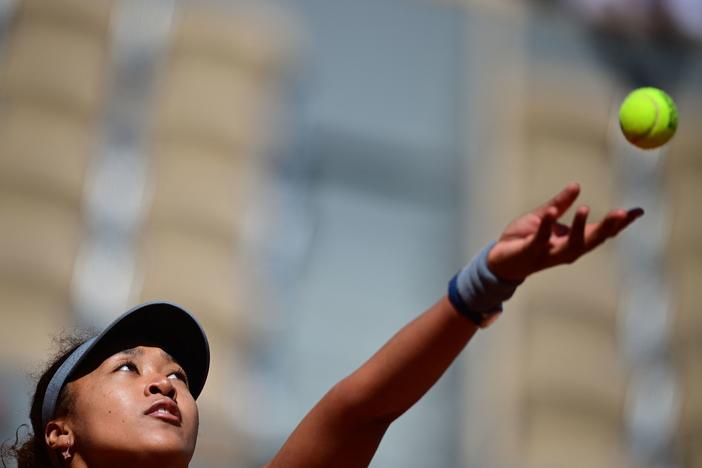 Japan's Naomi Osaka eyes the ball as she serves during the first round of the French Open tennis tournament Sunday in Paris.