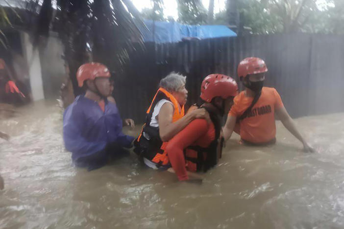 Rescuers take residents to safer ground as floods caused by Tropical Storm Dante hit Maasin City in Southern Leyte province, central Philippines. The tropical storm has left at least a few people dead and displaced hundreds of people in the southern and central Philippines.