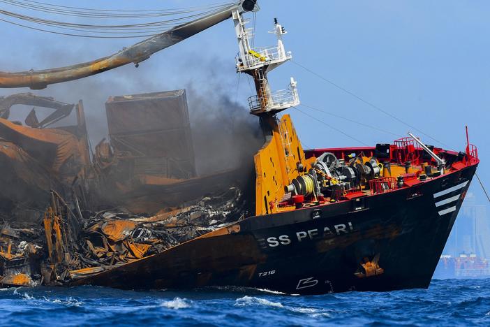 Smoke billows from the Singapore-registered container ship X-Press Pearl on Wednesday. The ship carries more than 80 containers of dangerous goods, including 25 tons of nitric acid.
