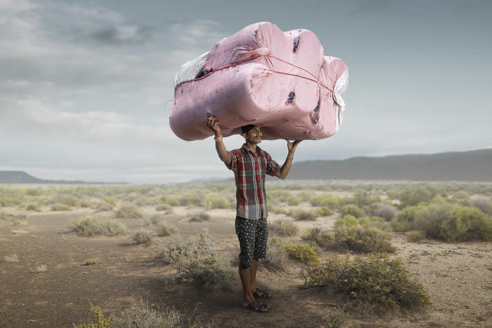First prize went to this image of a porter in Kolkata. Photographer Tom Price took the image, then created a different backdrop: an empty, unidentified landscape emphasizing the loneliness of the migrant worker.