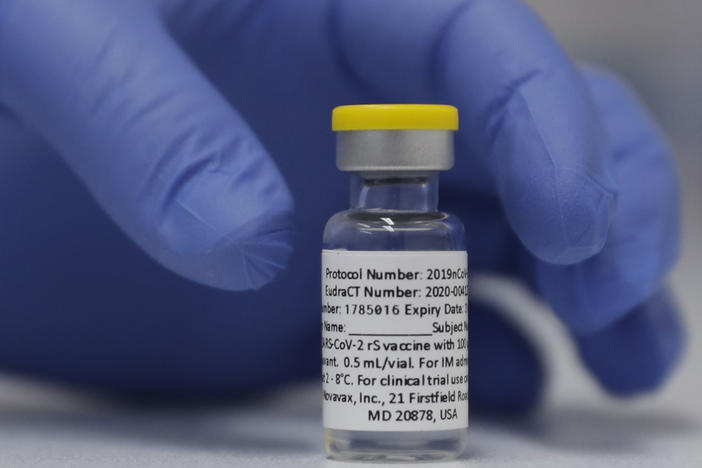 A vial of the experimental Novavax coronavirus vaccine is ready for use in a London study in 2020. Novavax's vaccine candidate contains a noninfectious bit of the virus — the spike protein — with a substance called an adjuvant added that helps the body generate a strong immune response.