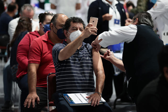 A man takes a selfie while getting the COVID-19 vaccine during a vaccination day in Mexico City.