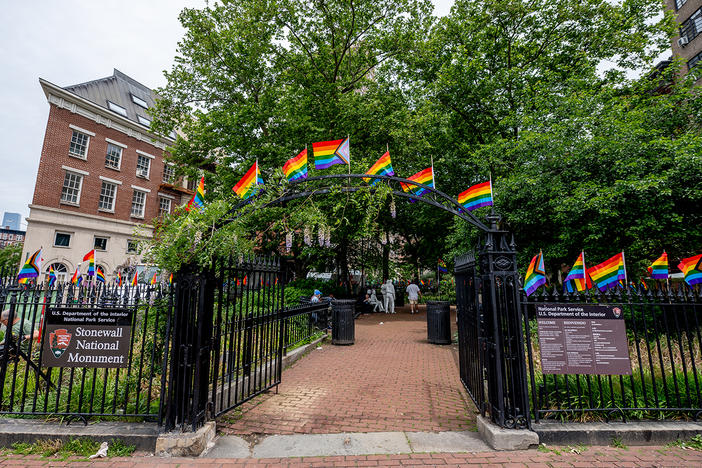 Pride flags decorate the Stonewall National Monument at Christopher Park in front of the Stonewall Inn. Many Pride events this year are more subdued due to pandemic precautions.