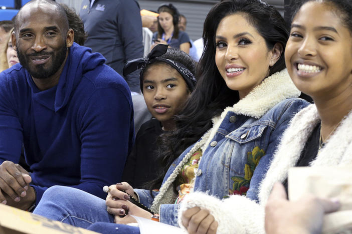 Basketball great Kobe Bryant (from left), daughter Gianna, wife Vanessa and daughter Natalia are seen before an NCAA college women's basketball game in 2017 in Los Angeles. Vanessa Bryant says Nike is making, without her consent, a shoe she designed in honor of her late daughter, Gianna.