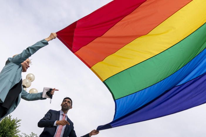 Energy Secretary Jennifer Granholm and Department of Energy Chief of Staff Tarak Shah help raise the Progress Pride Flag outside the DOE in Washington on Wednesday. The Pentagon decided not to allow the flag to fly on military installations for Pride Month.