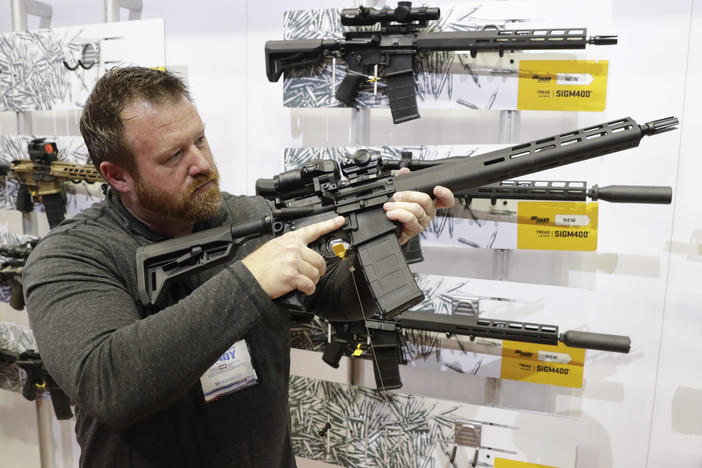 Bryan Oberc, in Munster, Ind., tries out an AR-15 from Sig Sauer in the exhibition hall at the National Rifle Association Annual Meeting in Indianapolis in 2019.