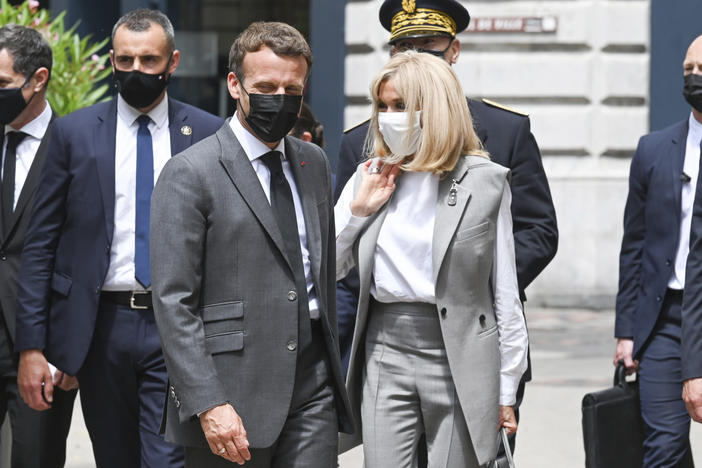 French President Emmanuel Macron and his wife, Brigitte, arrive for a lunch Tuesday in Valence, France. A man slapped the president in the face during the French leader's visit to a small town in southern France.