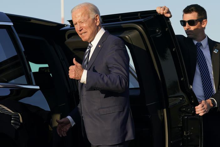 President Biden steps into a motorcade vehicle after arriving Wednesday at Royal Air Force Mildenhall in Suffolk, England, on the first leg of his European trip. "We have to end COVID-19, not just at home, which we're doing, but everywhere," he said.