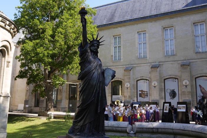 A mini replica of the French-designed Statue of Liberty will reach the U.S. on July 1. Here, the statue awaits its move in Paris on Monday.