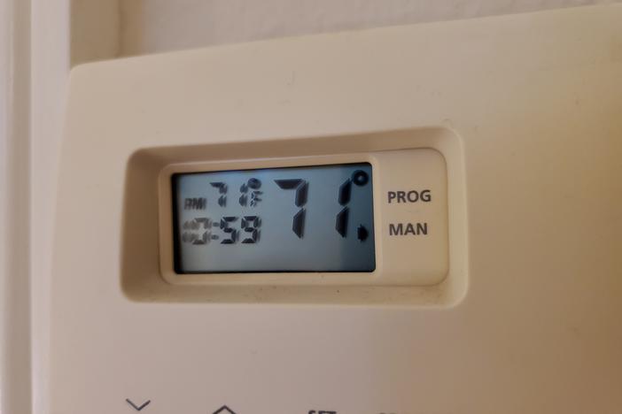 A wall-mounted thermostat in a California home. New research finds households that can least afford it are spending more than they have to on electricity.