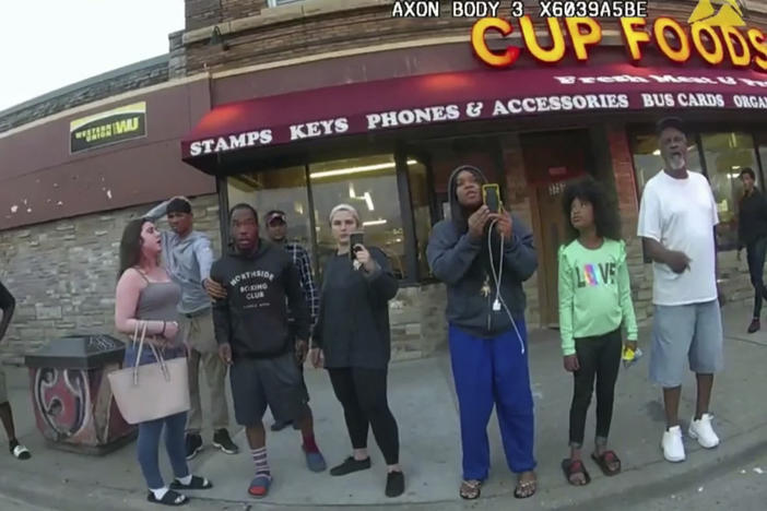 A police body camera image shows bystanders including Darnella Frazier (third from right filming) as former Minneapolis police officer Derek Chauvin was recorded pressing his knee on George Floyd's neck in Minneapolis.