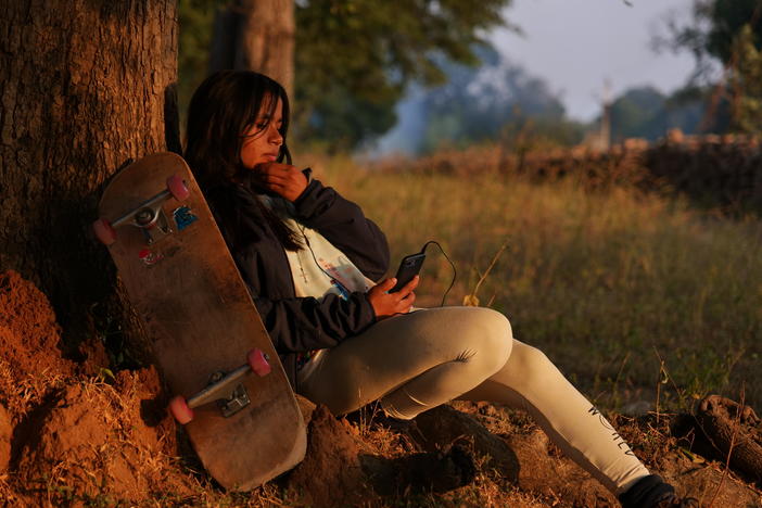 Asha Gond, 21, with her skateboard. She tried the sport when a skatepark was set up in her rural village and is now one of India's top female skateboarders.