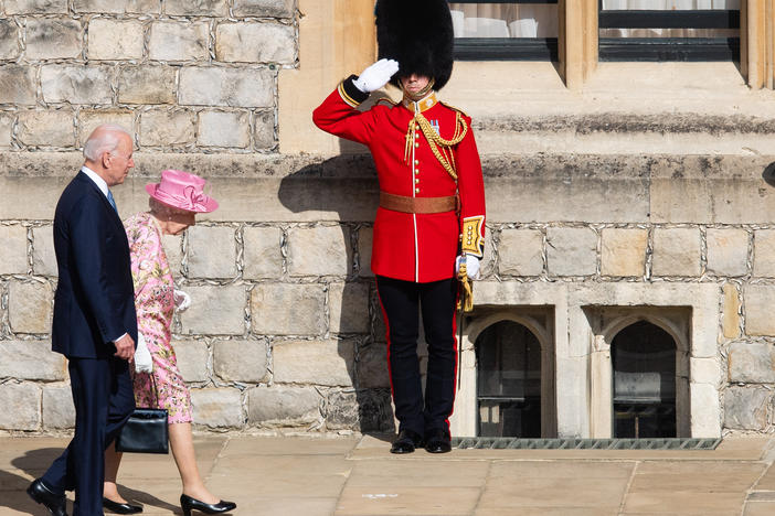 Queen Elizabeth II and President Biden walk at Windsor Castle on Sunday in Windsor, England. This is Biden's first private meeting with Queen Elizabeth II since becoming president.