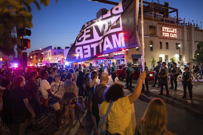 Protesters face police on June 6 in Minneapolis as they demand justice for Winston Boogie Smith Jr., who was fatally shot by members of a U.S. Marshals Fugitive Task Force. A woman at another Smith protest was killed Sunday after a vehicle drove into demonstrators.