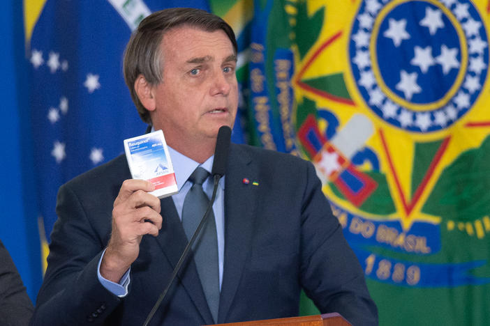 Brazilian President Jair Bolsonaro holds up a box of chloroquine, an antimalarial medicine that his administration endorsed as part of an "early treatment" strategy for COVID-19. There is no evidence the drug can prevent the coronavirus or reduce the severity of symptoms.