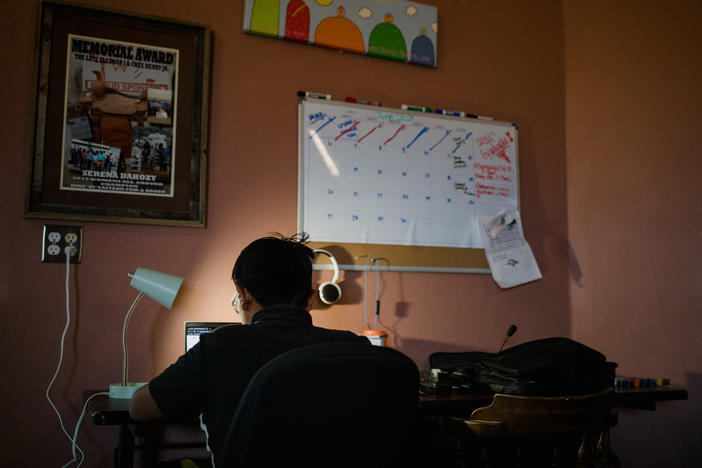 Domeniqu works on his computer at his home in Crownpoint.