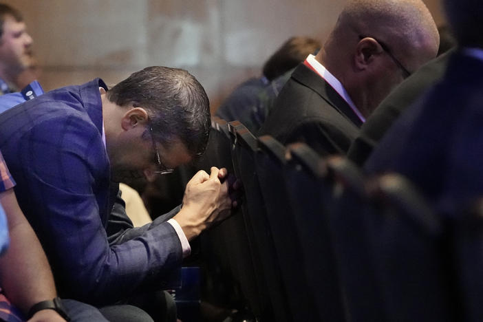 A man prays during the executive committee plenary meeting at the Southern Baptist Convention's annual gathering Monday in Nashville, Tenn.