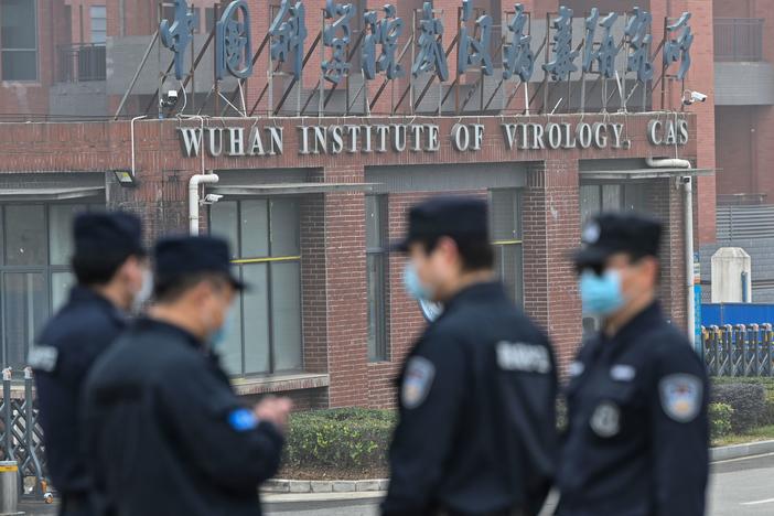 Security personnel stand guard outside the Wuhan Institute of Virology during the Feb. 3 visit of the World Health Organization team investigating the origins of the SARS-CoV-2, the virus that triggered a pandemic.