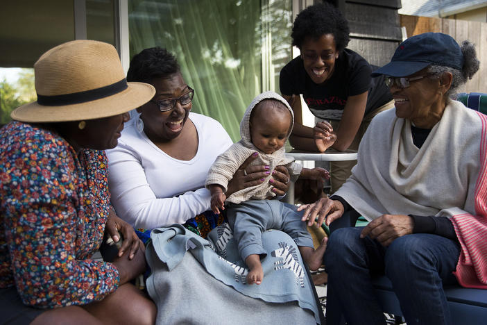 Cassandra Cast (second from  left) and Barbara Arthur (right) traveled to Washington state from Boston and Atlanta, respectively, to meet their grandson for the first time.
