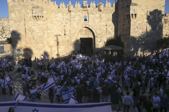 Jewish ultranationalists take part in a flag-waving march Tuesday next to the Damascus Gate, outside Jerusalem's Old City.