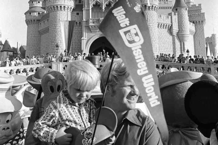 When Disney World opened on Oct. 1, 1971, tickets for adults were just $3.50. Here, William Windsor Jr. carries his son Lee, past Cinderella's castle on opening day.