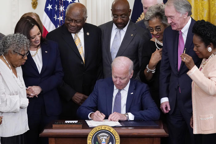 President Biden signs the Juneteenth National Independence Day Act in the East Room of the White House on Thursday.