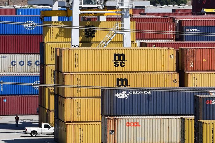 Shipping containers are stacked high at the Port of Los Angeles in April. Supply chain disruptions are hitting small-business owners across the United States.