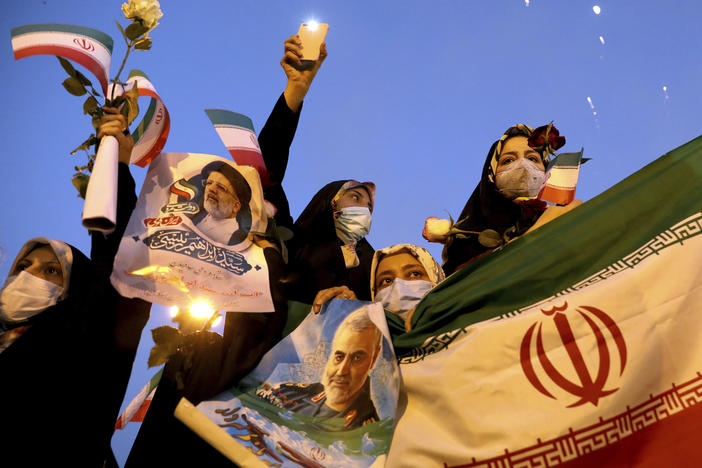 Supporters of Iranian President-elect Ebrahim Raisi celebrate in Tehran on Saturday after he won the presidential election.