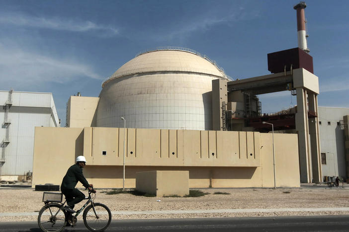 In this 2010 file photo, a worker rides a bicycle in front of the reactor building of the Bushehr nuclear power plant, just outside the southern city of Bushehr. Iran's sole nuclear power plant has undergone a temporary emergency shutdown, state TV reported on Sunday.