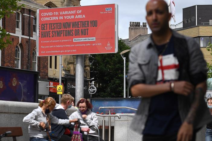 A sign urges people to get tested for a COVID-19 variant in Blackburn, England. The U.K. is experiencing a surge in the delta variant, which was first identified in India.