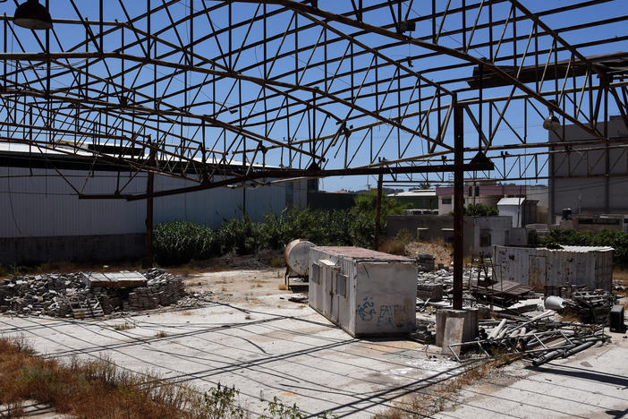 Faysal Shawa's warehouse was damaged in the 2014 conflict. Shawa and employees maintain no connection to Hamas.