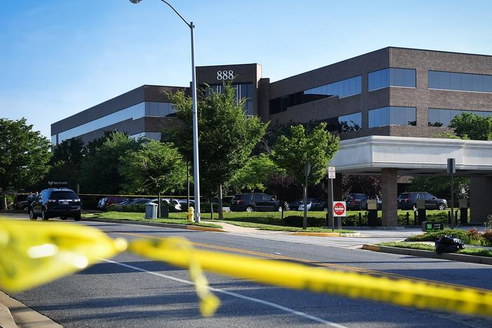 Police tape blocks access from a street leading to the building complex where the Capital Gazette is located on June 29, 2018, in Annapolis, Md. The suspect barricaded a back door in an effort to "kill as many people as he could kill," police said.