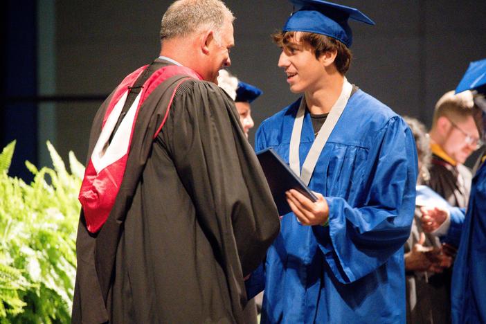 Matanzas High School Principal Jeff Reaves shakes a student's hand on graduation day. Reaves handwrote 459 notes to the graduating class of 2021 to celebrate their accomplishments.