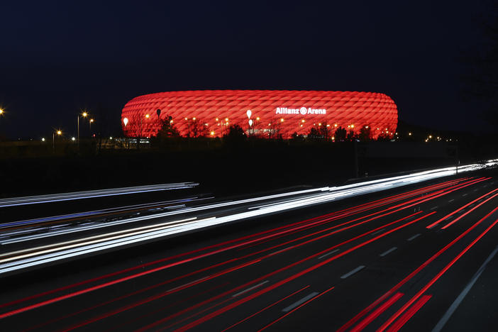 In a photo from March of last year, cars pass the illuminated Allianz Arena soccer stadium in Munich, Germany. UEFA has denied a request by the stadium to light up in rainbow colors Wednesday to protest a new Hungarian law seen as homophobic.