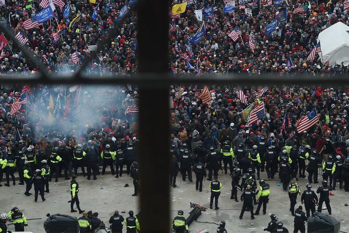 Police hold back rioters gathered outside the U.S. Capitol on Jan. 6. New body camera footage released by the Justice Department shows the violence of that day from the perspective of the officers themselves.
