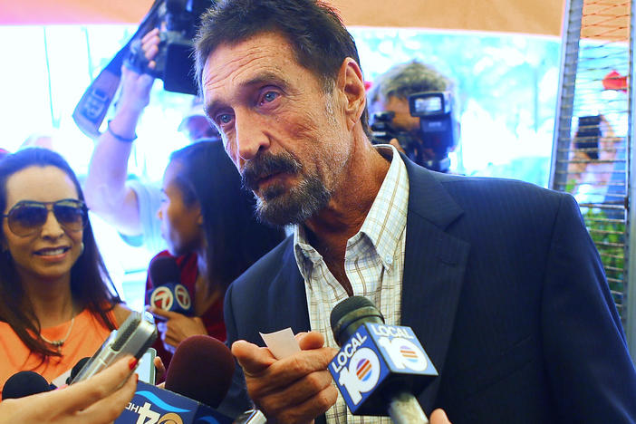 John McAfee talks to the media outside Beacon Hotel where he stayed after arriving from Guatemala in December 2012 in Miami Beach, Fla. McAfee was found dead in a Spanish prison cell on Wednesday, according to his lawyer.