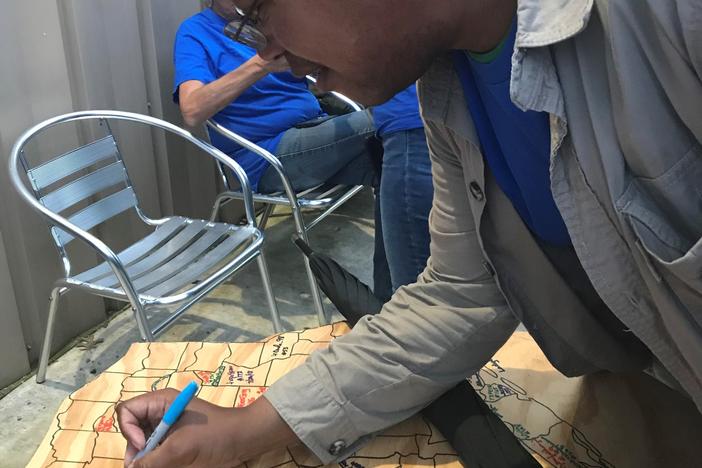 Marcellus Cadd signing his name in Round Rock, Texas, after finding a cache in all 254 counties in the state.