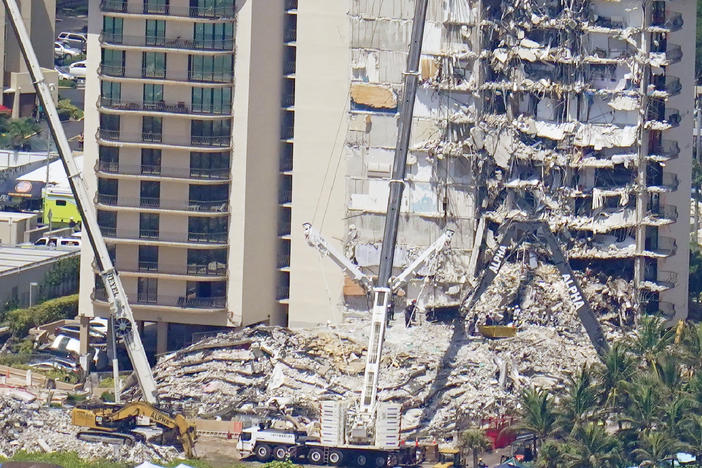 Crews work near a open tunnel, center near the bottom, in the rubble at the Champlain Towers South Condo on Sunday in Surfside, Fla. More than 150 people were still unaccounted for two days after Thursday's collapse.