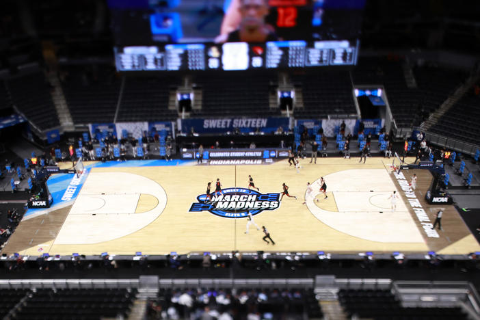 The March Madness logo on the court during the Sweet Sixteen round of the 2021 NCAA Men's Basketball Tournament in Indianapolis. Soon, some college athletes can get money when using their name, image or likeness.