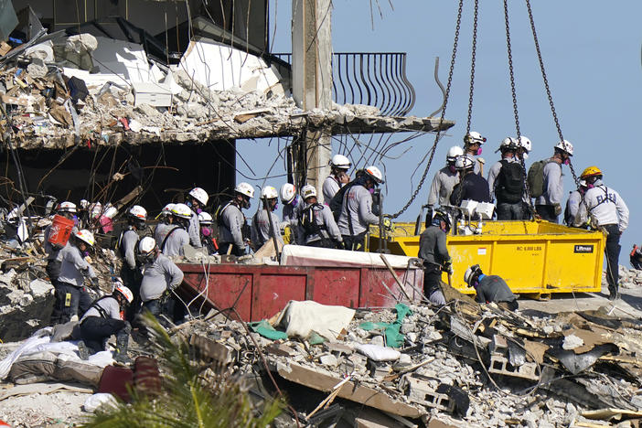 Rescue workers search for survivors in the rubble at the Champlain Towers South condo building Monday in Surfside, Fla. Some 150 people remain unaccounted for after the building partially collapsed last week.