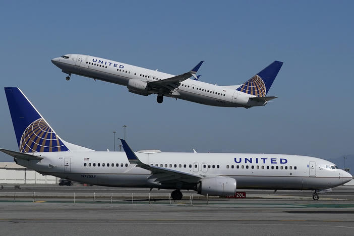 A United Airlines plane takes off over another plane on the runway at San Francisco International Airport last year. United Airlines has announced a new order of 270 narrow-bodied planes from Boeing and Airbus.